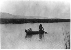 Timeless image of a Pomo Indian in a tule boat near Upper Lake,  California (circa 1924).