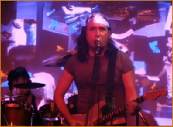 Swaybone performing, 
with Adi Da's Image-Art in the background